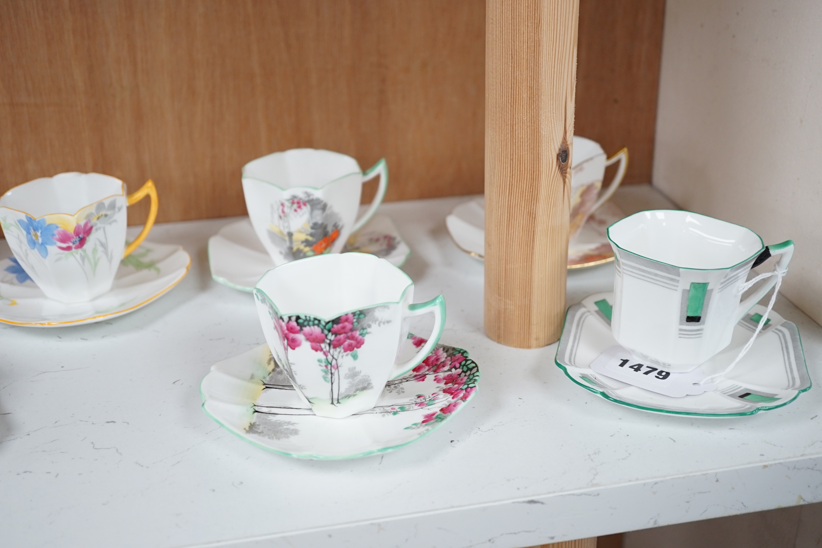 Seven Shelley Art Deco cups and saucers, three trios and a milk jug, some with Art Deco designs, largest 13cm wide